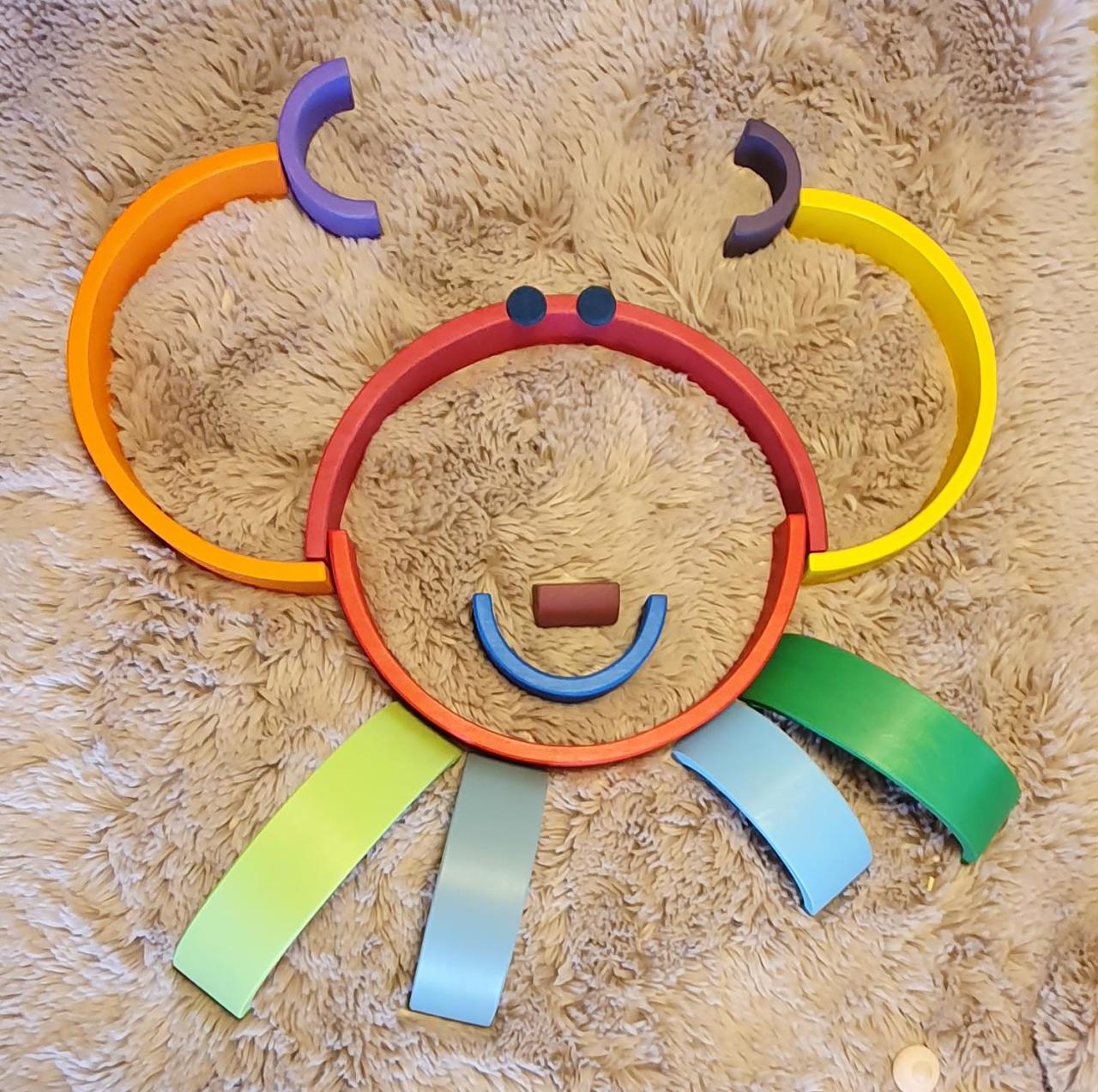 Wooden rainbow pieces arranged creatively for Waldorf education
